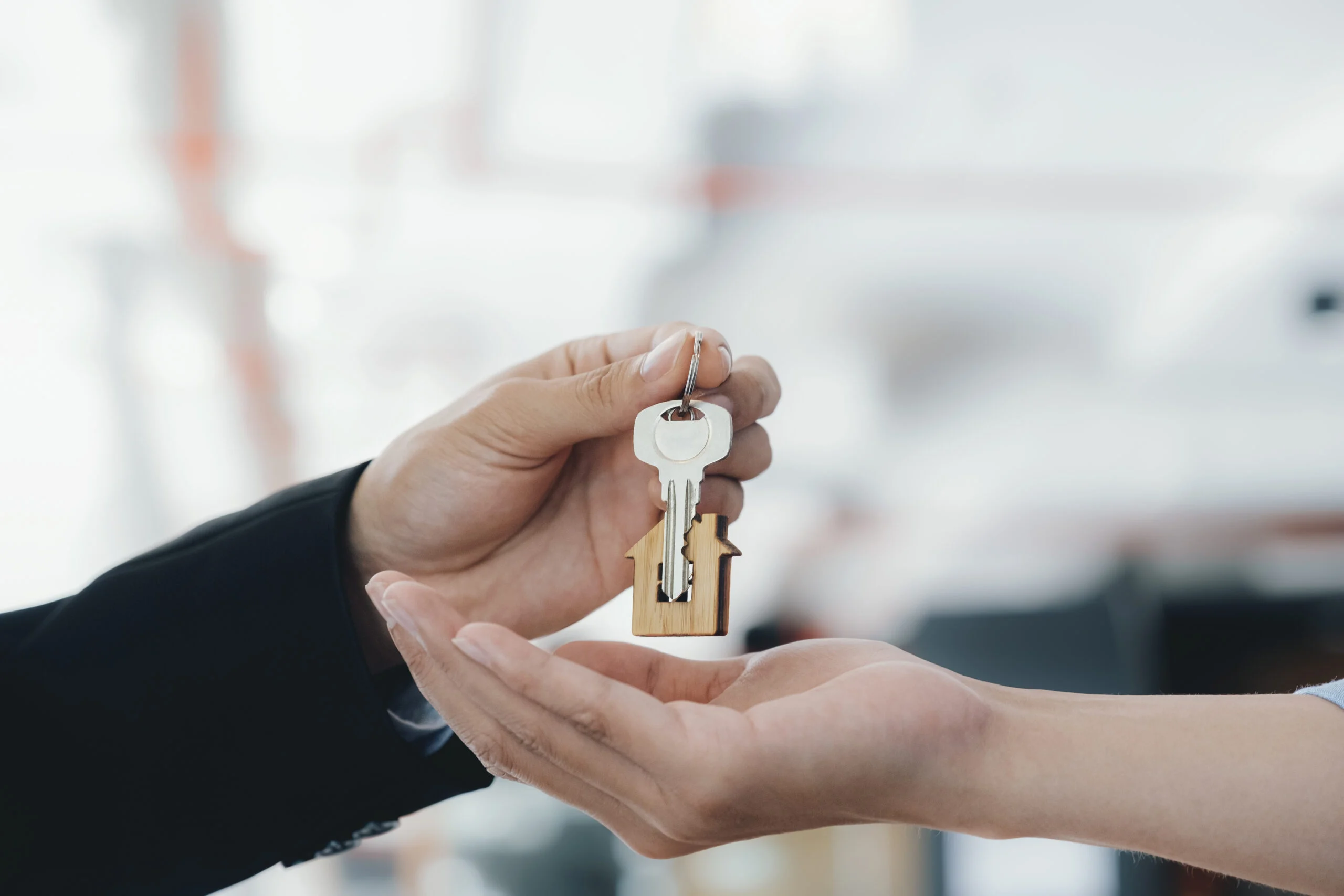 real estate agent holding key with house shaped k 2025 03 25 06 57 12 utc