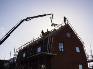 silhouette of men and crane at construction site 2024 10 18 04 48 36 utc