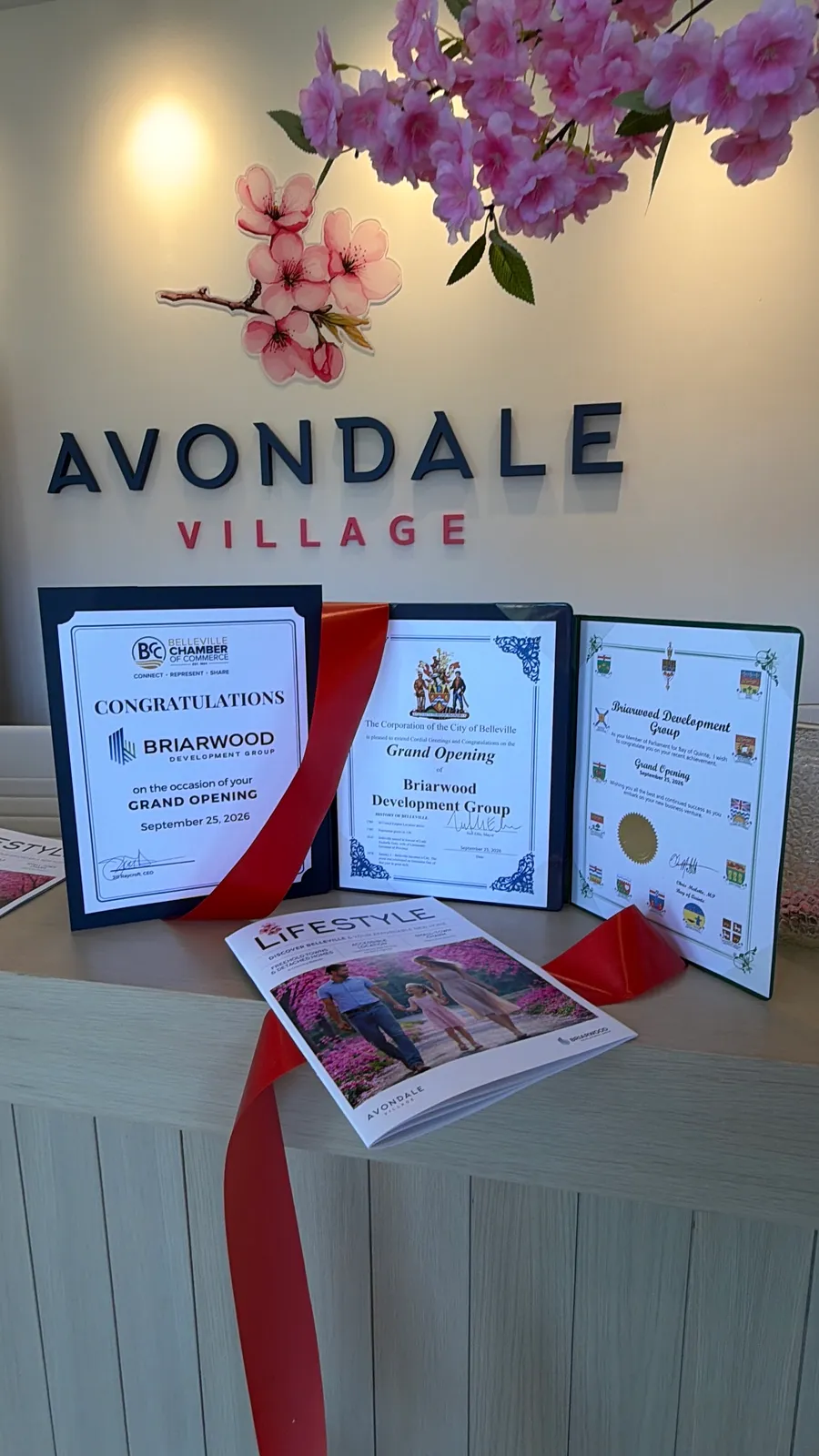 Grand opening congratulations certificates displayed at the Avondale Village sales centre in Belleville