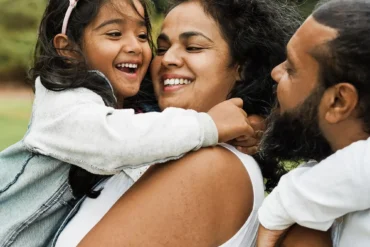 Family embracing outdoors representing Kingshaven by Kingsmen Group in Markham
