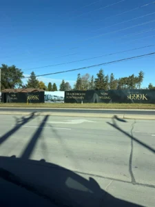 Construction hoarding at Livewell on Wellington in Aurora advertising 3 and 4 bedroom townhomes now selling from $699K