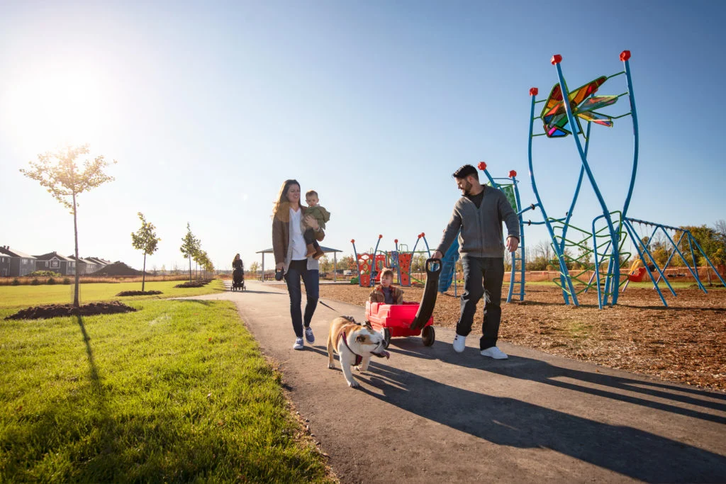 Family on a pathway beside a playground near Fox Run in Richmond Village, Ottawa
