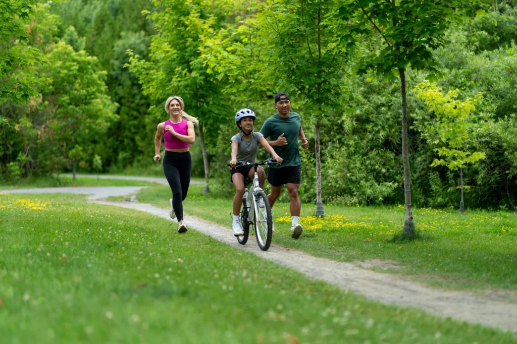 Family running and cycling on a trail near Magnolia in Stittsville, Ottawa