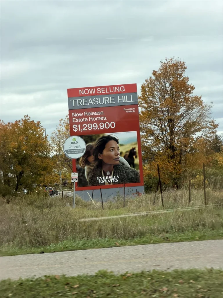 Treasure Hill roadside sign for Eversley Estates in King City advertising new release estate homes at $1,299,900 with bungalows available